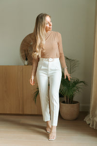 White pants with golden buckle